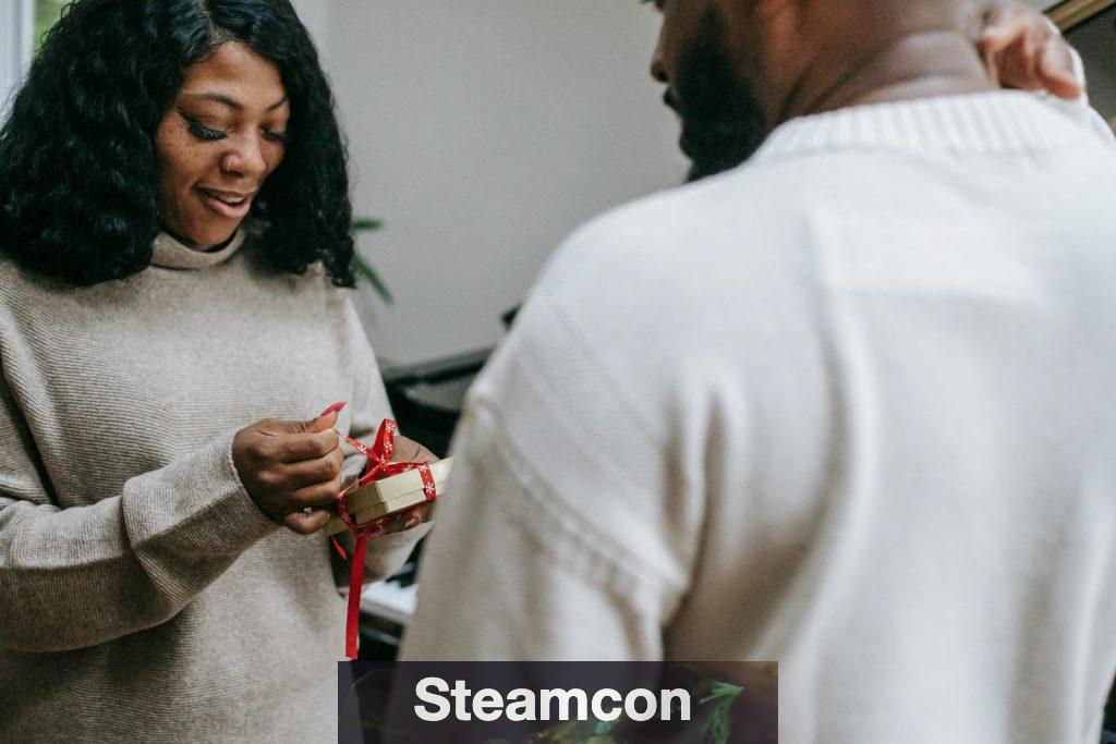 Black couple in sweaters congratulating each other on Christmas