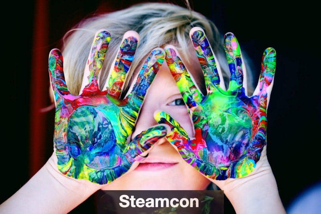 Vibrant close-up of a child's hands covered in colorful paint, expressing creativity and fun.